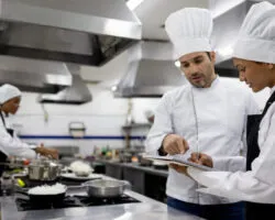 Chef talking to a student in a cooking class