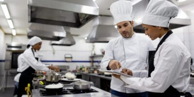 Chef talking to a student in a cooking class