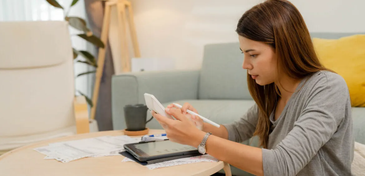 Woman analyzing documents while sitting at home.