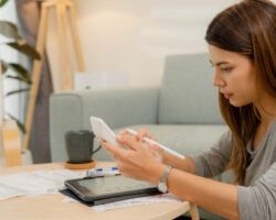 Woman analyzing documents while sitting at home.