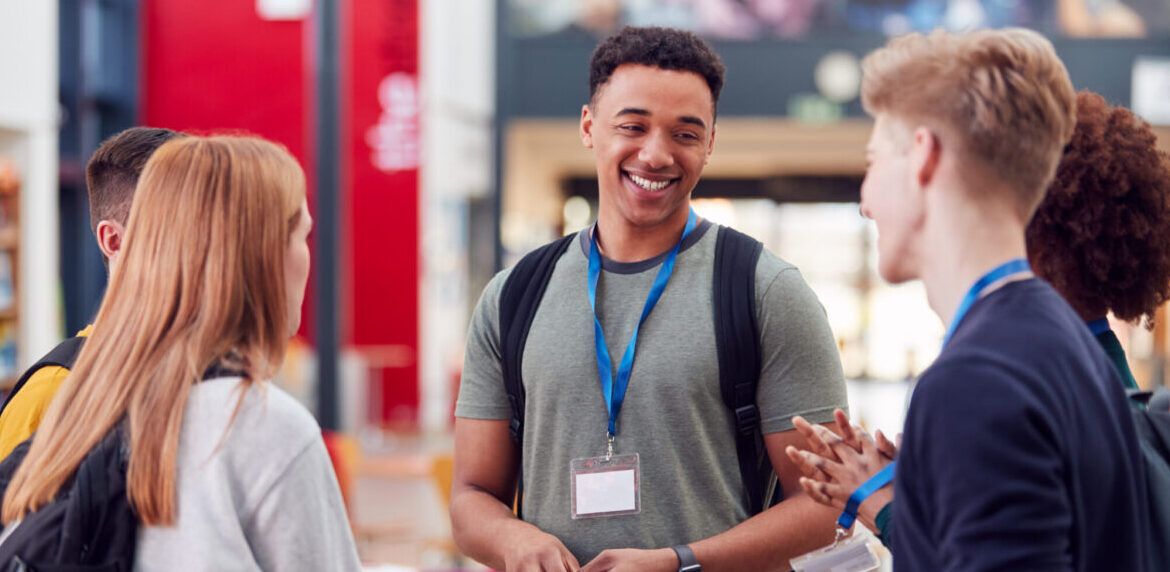 Group Of university Student Friends Meeting And Talking In Busy Communal Campus Building