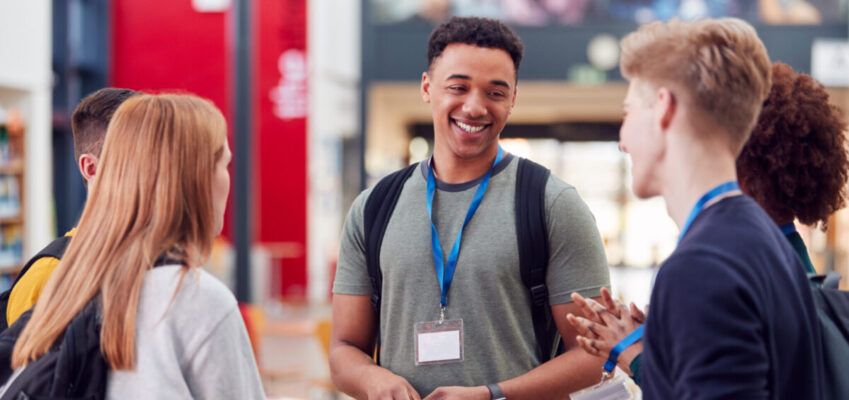 Group Of university Student Friends Meeting And Talking In Busy Communal Campus Building