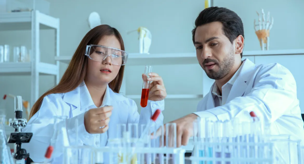 male and female conducting experiments in lab