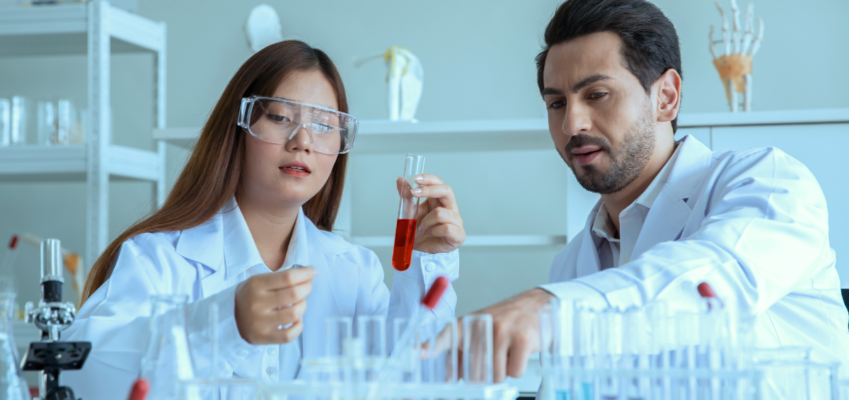 male and female conducting experiments in lab