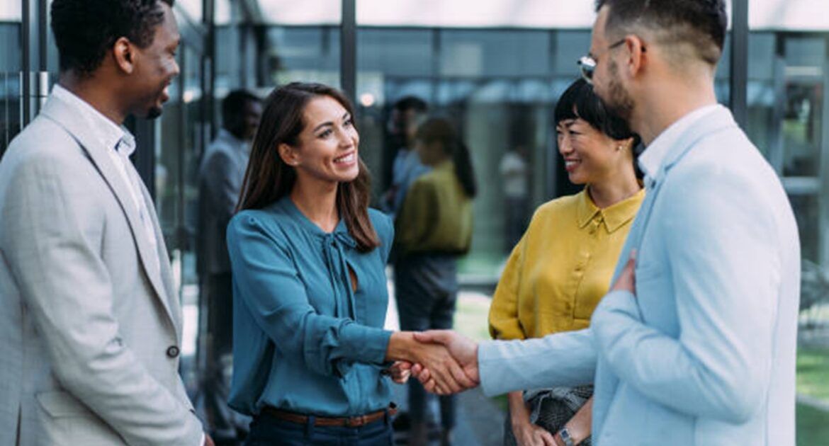 New worker shaking hands with team